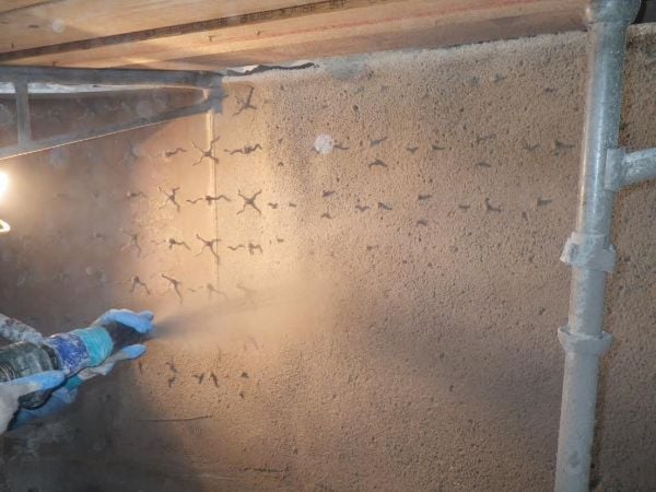 Wet gunned mix being applied onto a system of anchors. (Image from “What is Refractory?”, originally published in the July/August 2016 issue of Inspectioneering Journal)